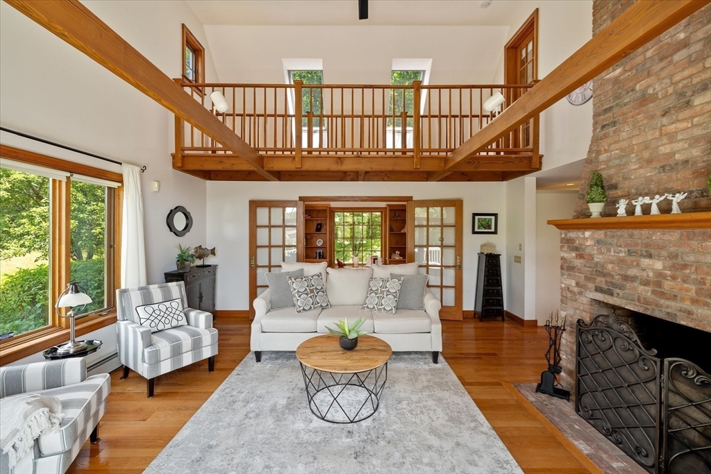 58 Rice Corner Road Brookfield, MA 01506 - Photo 15 of 41 a living room with furniture a fireplace and a floor to ceiling window