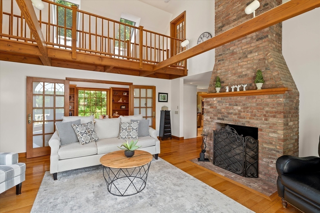 58 Rice Corner Road Brookfield, MA 01506 - Photo 16 of 41 a living room with furniture a fireplace and a floor to ceiling window