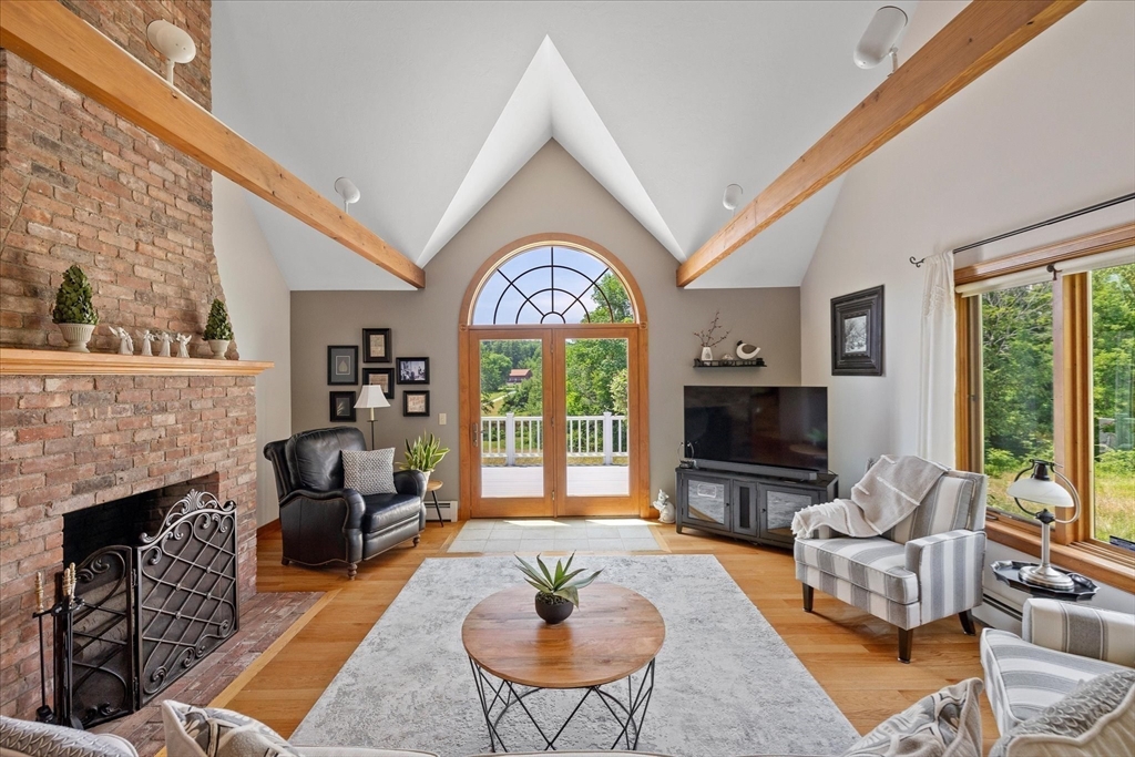 58 Rice Corner Road Brookfield, MA 01506 - Photo 17 of 41 a living room with furniture a fireplace and a flat screen tv