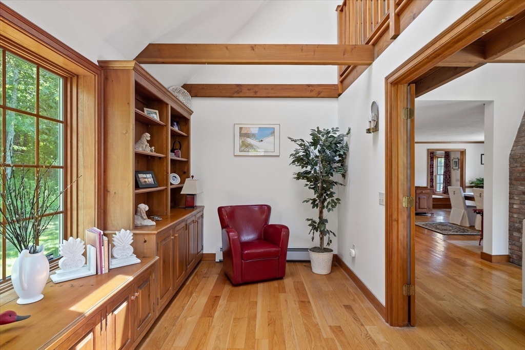 58 Rice Corner Road Brookfield, MA 01506 - Photo 19 of 41 a hallway with a potted plant and a large window with wooden floor
