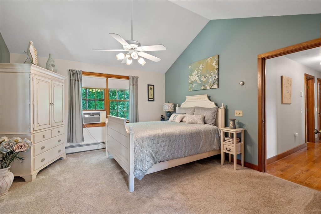 58 Rice Corner Road Brookfield, MA 01506 - Photo 21 of 41 a bedroom with a large bed and a chandelier