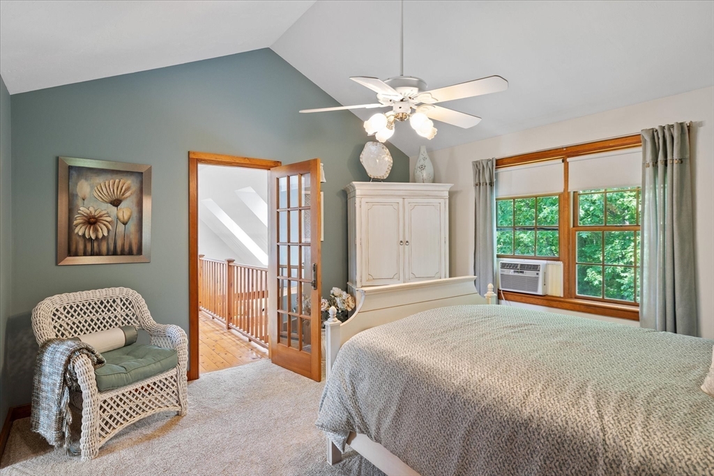 58 Rice Corner Road Brookfield, MA 01506 - Photo 23 of 41 a bedroom with a bed and a chandelier