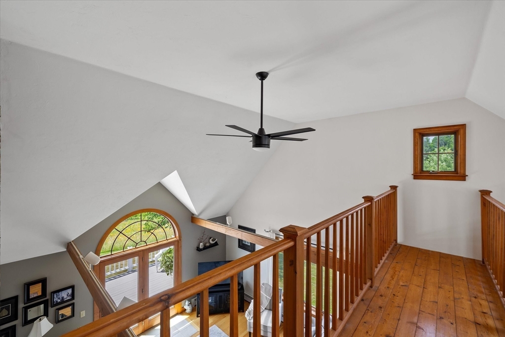 58 Rice Corner Road Brookfield, MA 01506 - Photo 24 of 41 a view of a hallway with wooden floor and a ceiling fan