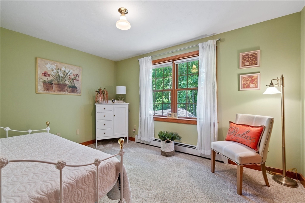 58 Rice Corner Road Brookfield, MA 01506 - Photo 29 of 41 a bedroom with a bed and a chair