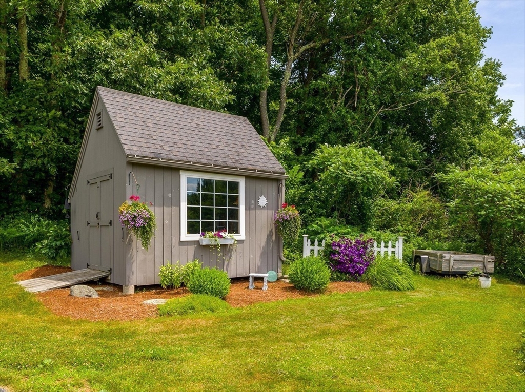 58 Rice Corner Road Brookfield, MA 01506 - Photo 38 of 41 a front view of a house with a yard and garage