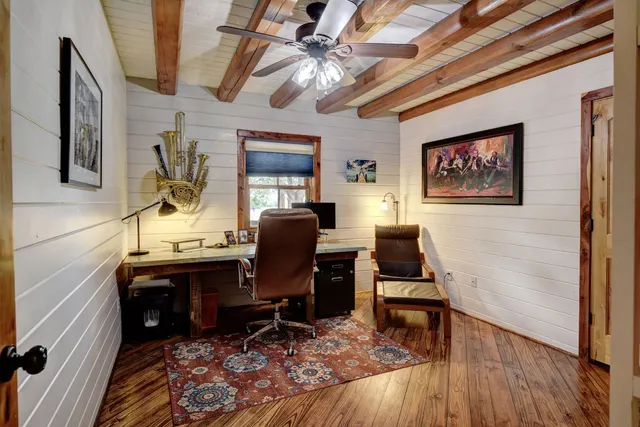a view of a workspace with furniture and a window