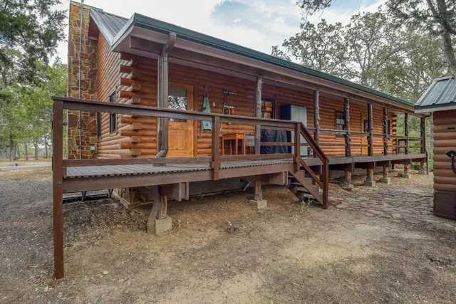 a backyard of a house with barbeque oven and outdoor seating