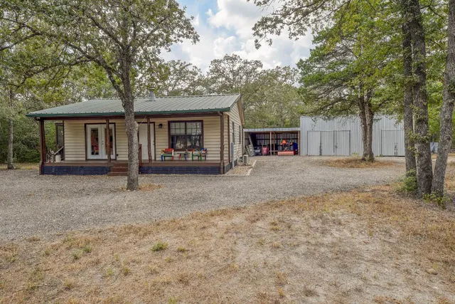 front view of a house with a large tree