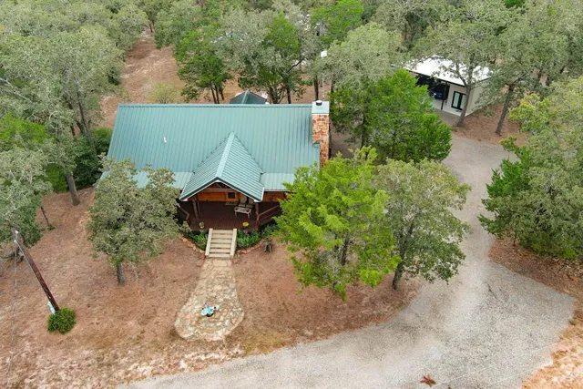 an aerial view of a house with a yard