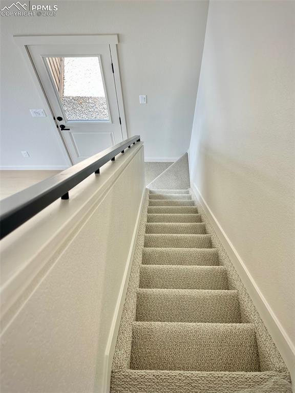 3535 Greenways Main Boulevard Colorado Springs, CO 80922 - Photo 18 of 22 a view of staircase with white walls and a window