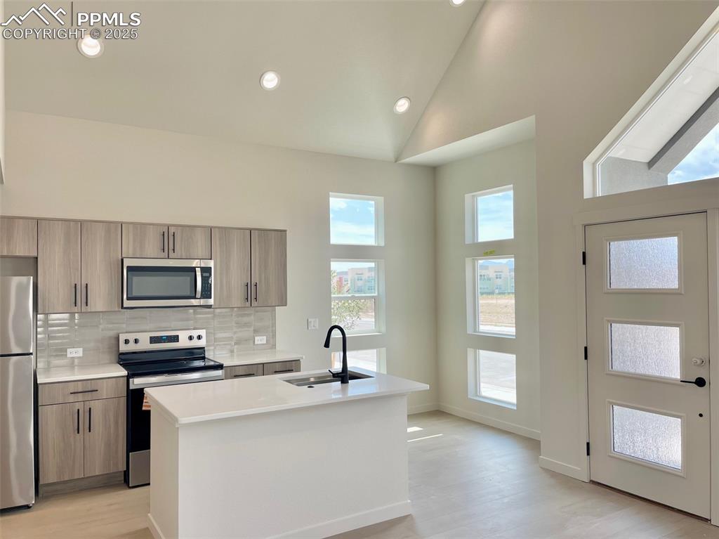 3535 Greenways Main Boulevard Colorado Springs, CO 80922 - Photo 6 of 22 a kitchen with granite countertop a sink stove and refrigerator