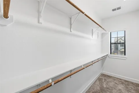 a spacious bathroom with a double vanity sink a mirror and a shower