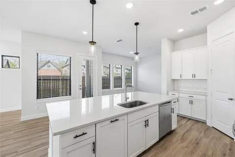 a large white kitchen with a large window