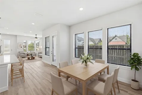 a view of a livingroom with furniture and floor to ceiling window