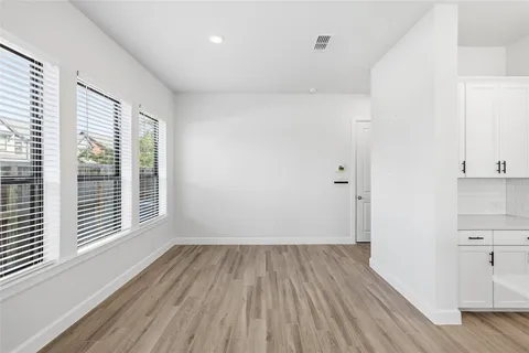 a view of a room with wooden floor and windows