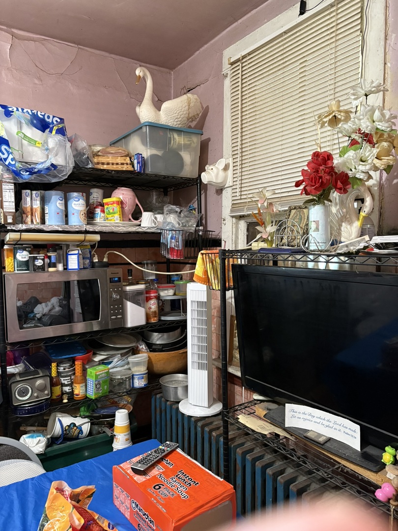 8750 South Exchange Avenue Chicago, IL 60617 - Photo 5 of 11 a kitchen area with stainless steel appliances kitchen island granite countertop a stove and cabinets