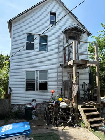 a view of house with a door and outdoor seating