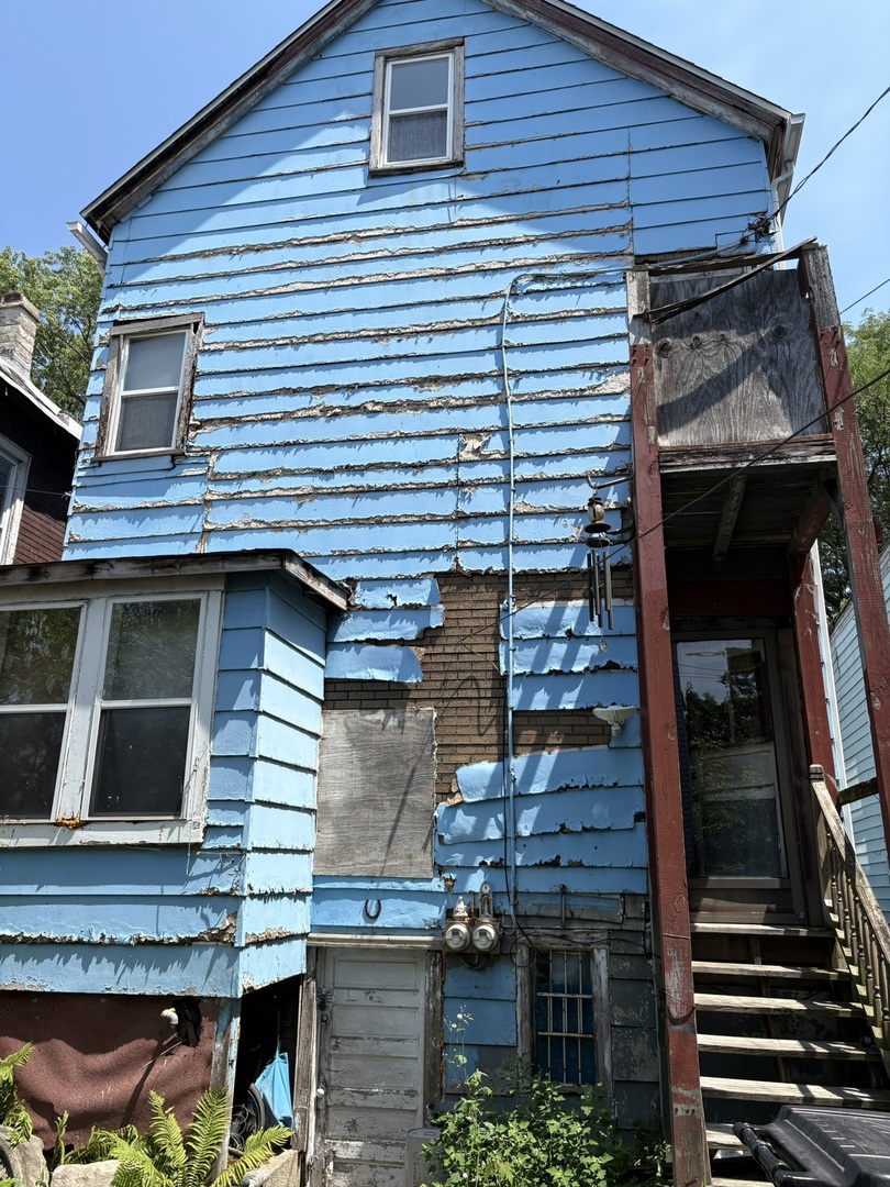 8750 South Exchange Avenue Chicago, IL 60617 - Photo 9 of 11 a view of house with a door and outdoor seating