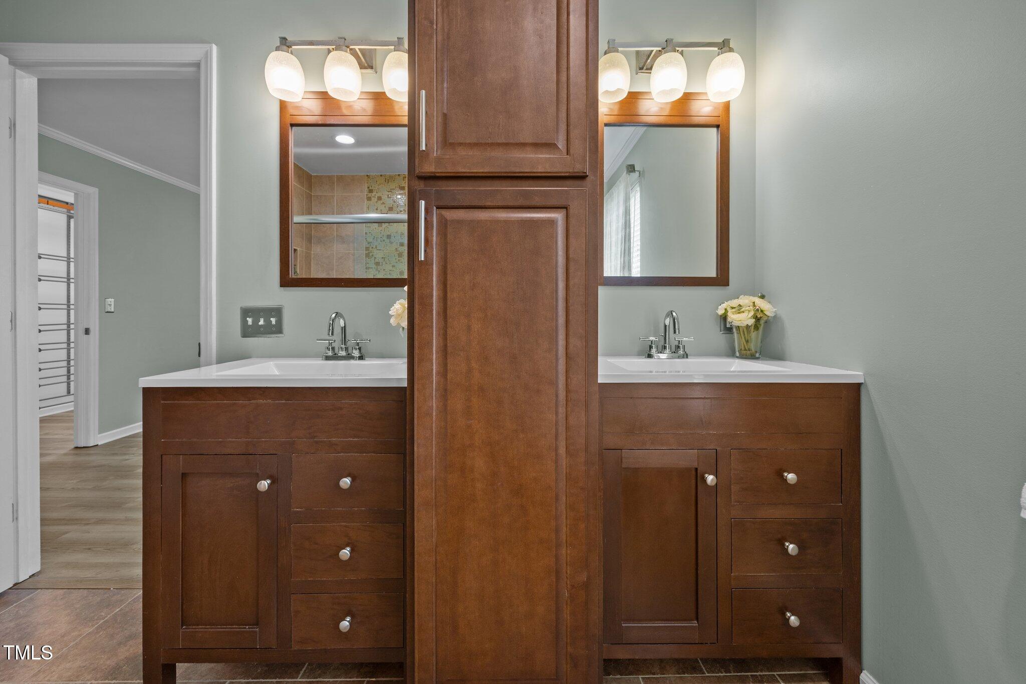 5561 Roan Mountain Place Raleigh, NC 27613 - Photo 10 of 20 a bathroom with a sink and a mirror