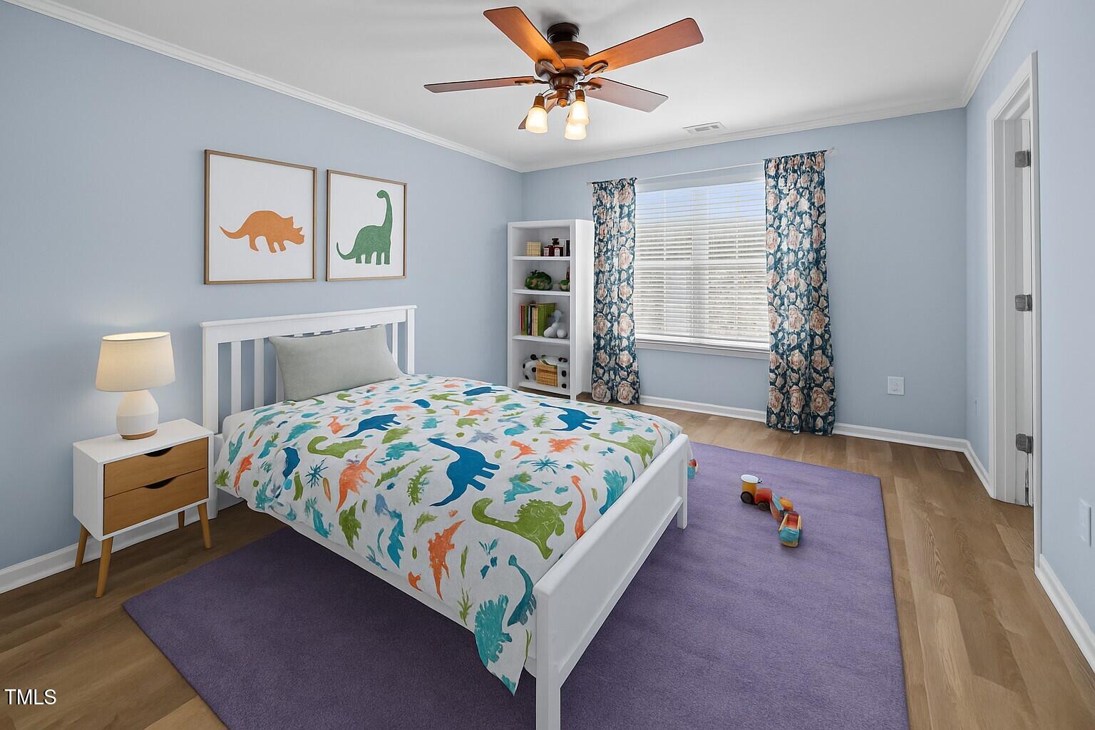 5561 Roan Mountain Place Raleigh, NC 27613 - Photo 12 of 20 a bedroom with a bed dresser and a window