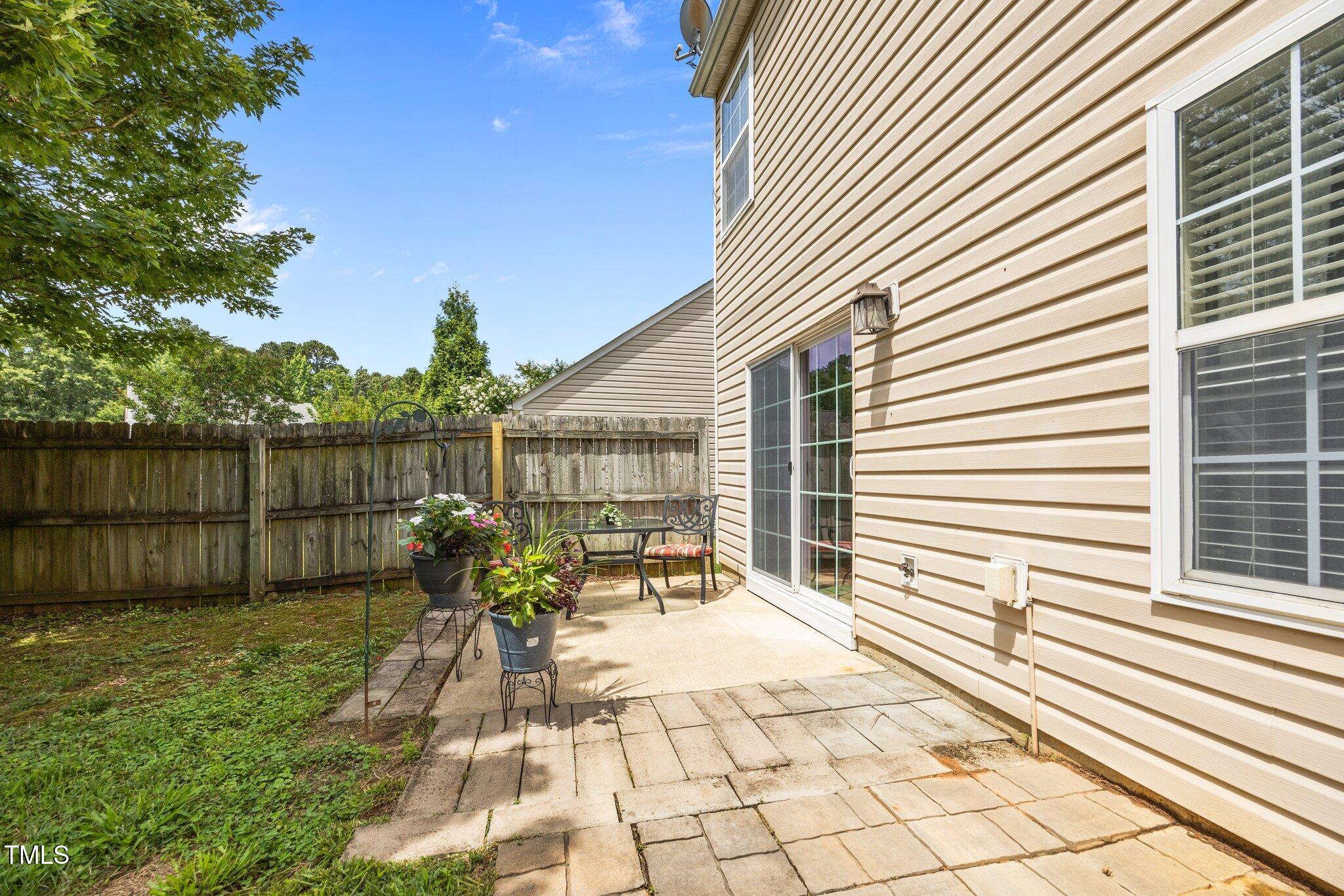 5561 Roan Mountain Place Raleigh, NC 27613 - Photo 16 of 20 a view of a patio with a table and chairs