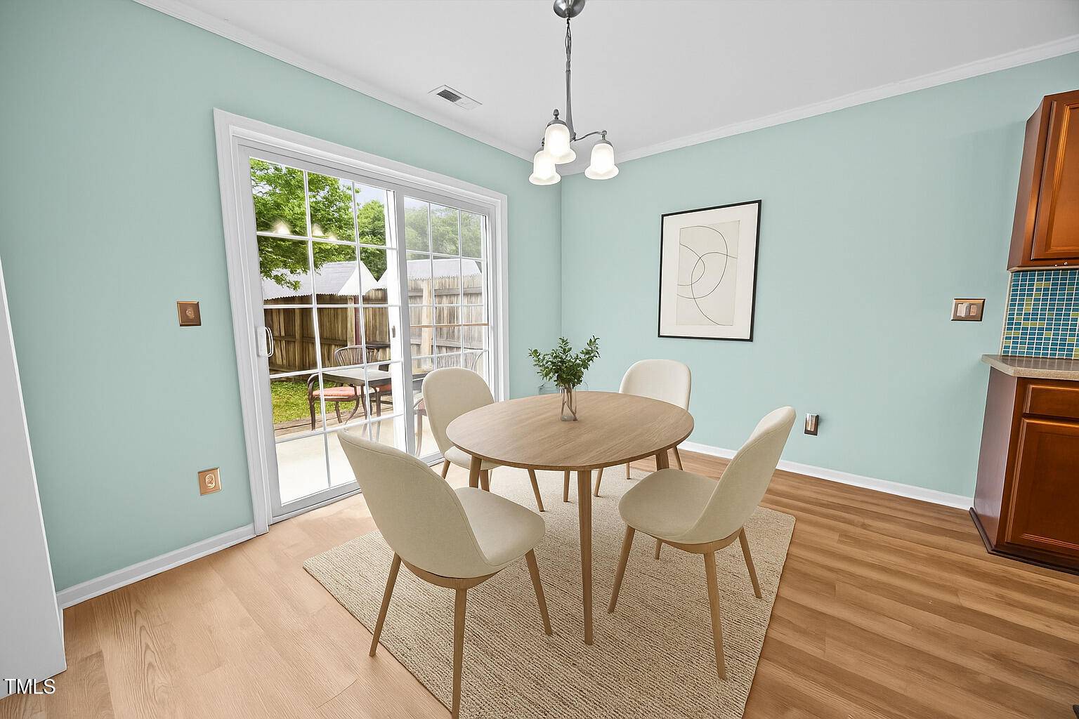 5561 Roan Mountain Place Raleigh, NC 27613 - Photo 6 of 20 a view of a dining room with furniture window and wooden floor