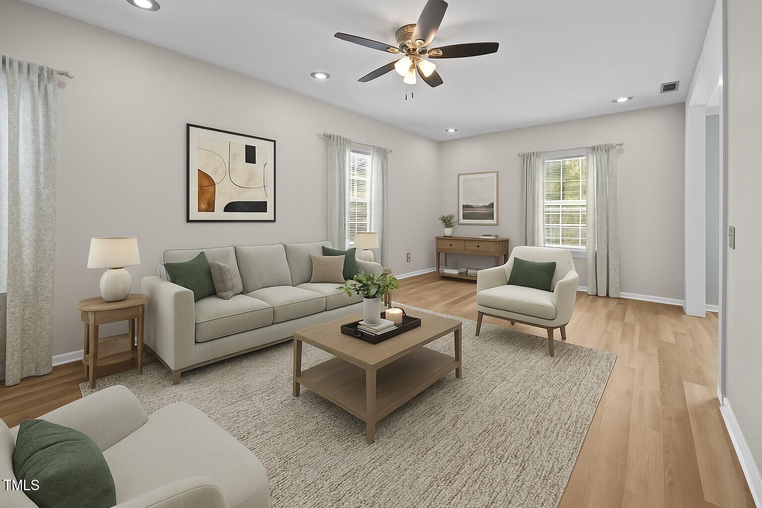 5561 Roan Mountain Place Raleigh, NC 27613 - Photo 7 of 20 a living room with furniture and a wooden floor