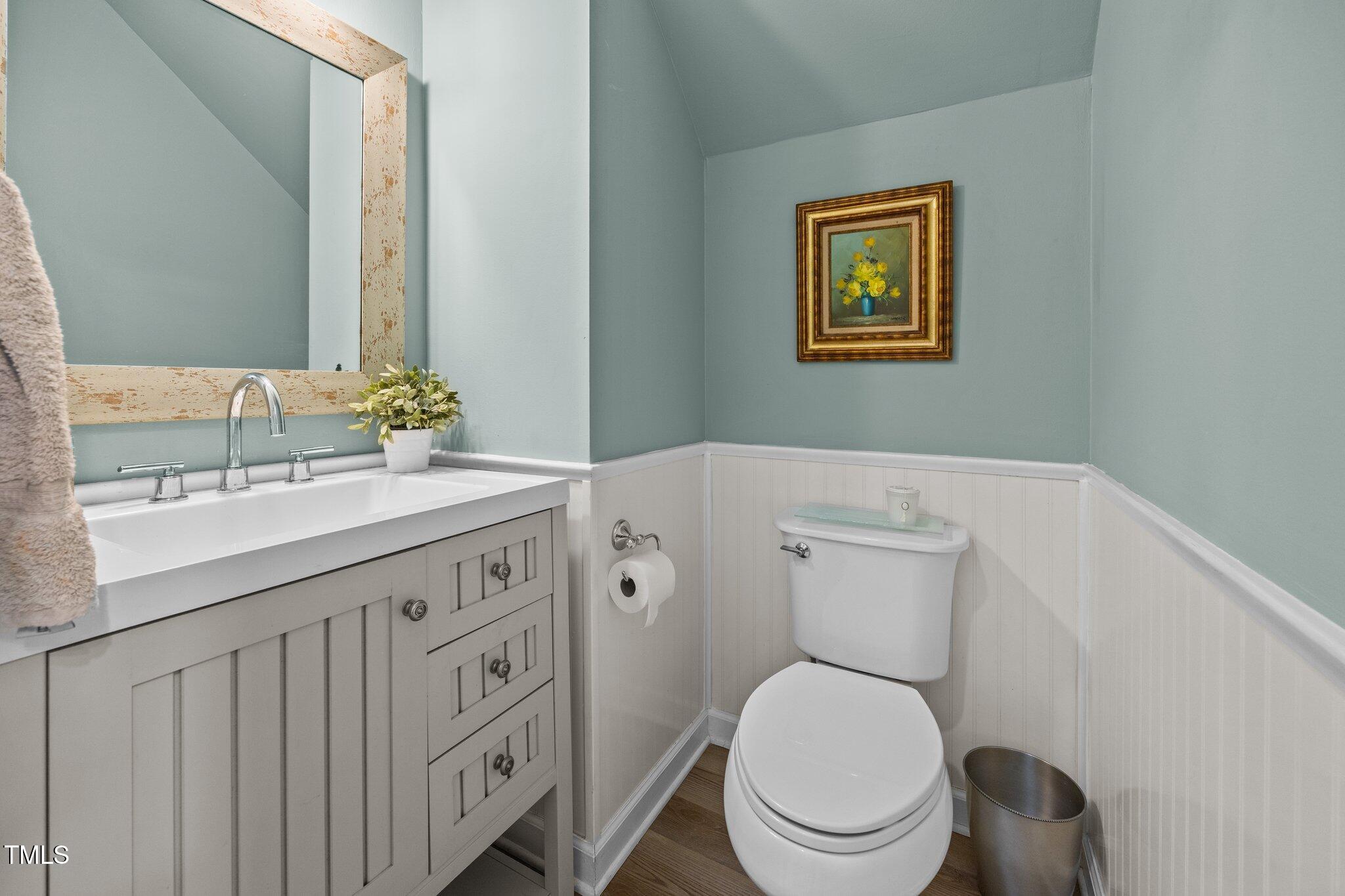 5561 Roan Mountain Place Raleigh, NC 27613 - Photo 8 of 20 a spacious bathroom with a toilet a sink a mirror and a window