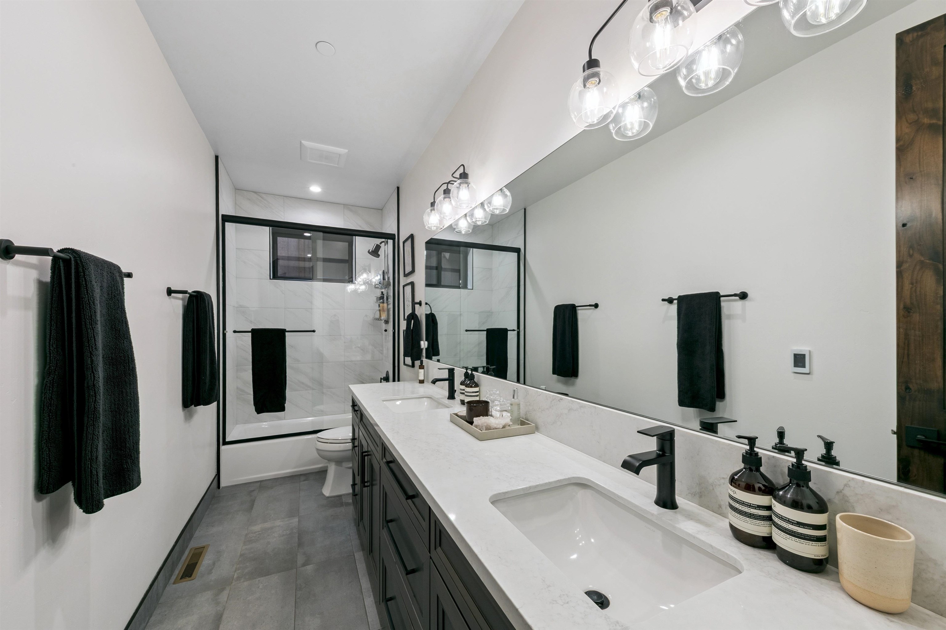 7247 9th Avenue Tahoma, CA 96142 - Photo 27 of 28 a bathroom with a double vanity sink and a mirror