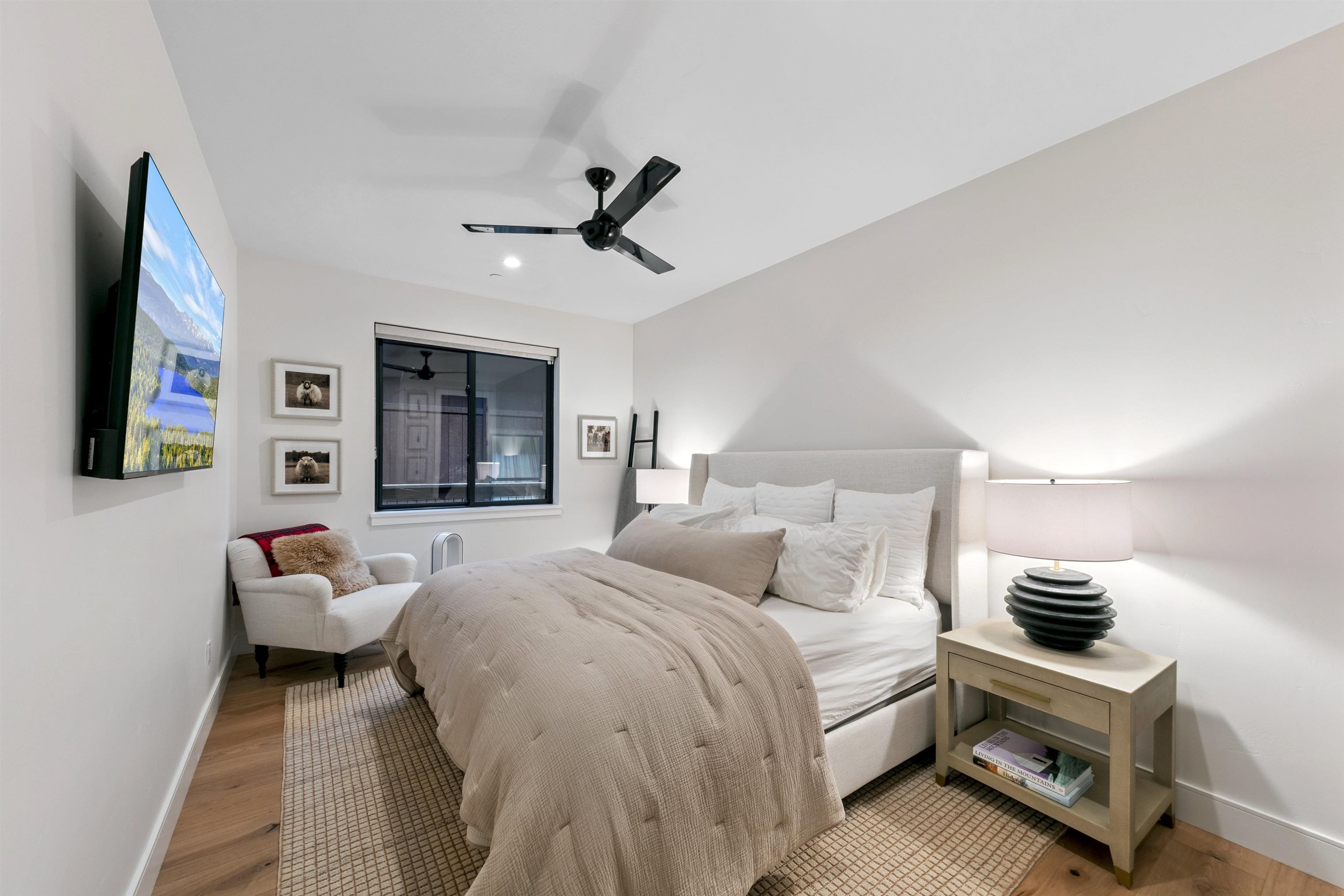 7247 9th Avenue Tahoma, CA 96142 - Photo 28 of 28 a bedroom with a bed and a chandelier