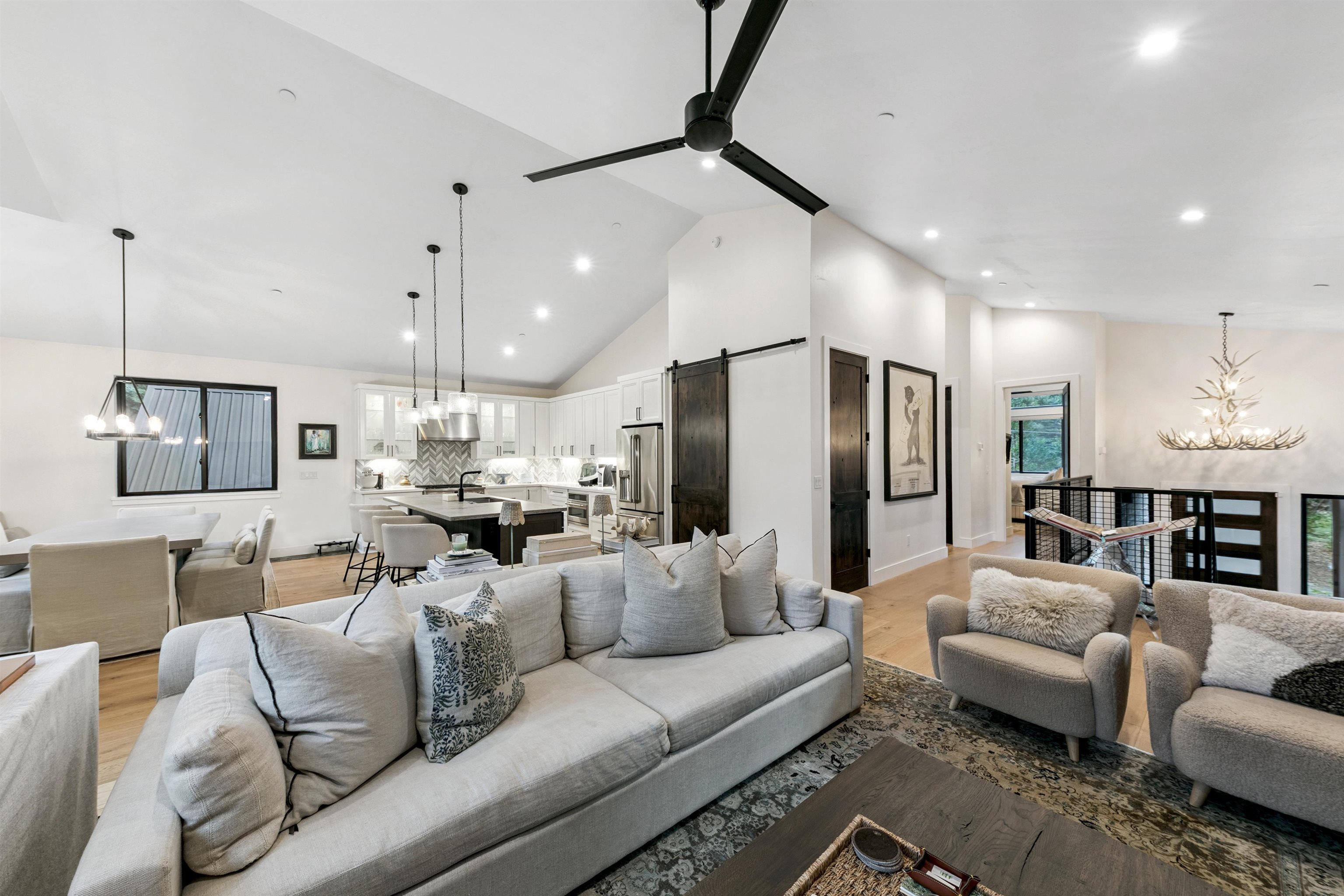 7247 9th Avenue Tahoma, CA 96142 - Photo 9 of 28 a living room with furniture kitchen view and a chandelier