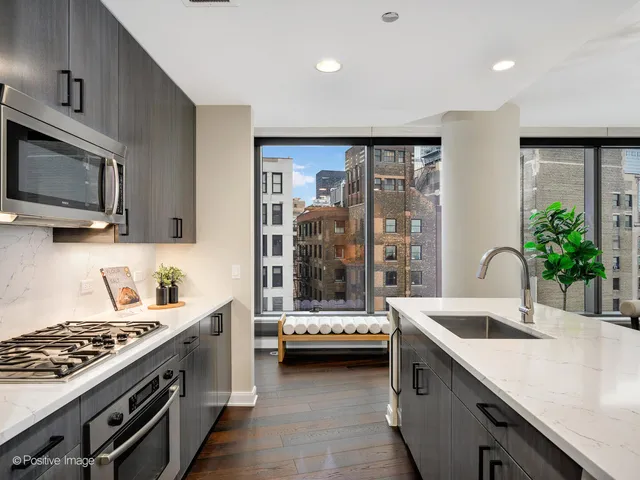 a kitchen with a sink and a stove top oven