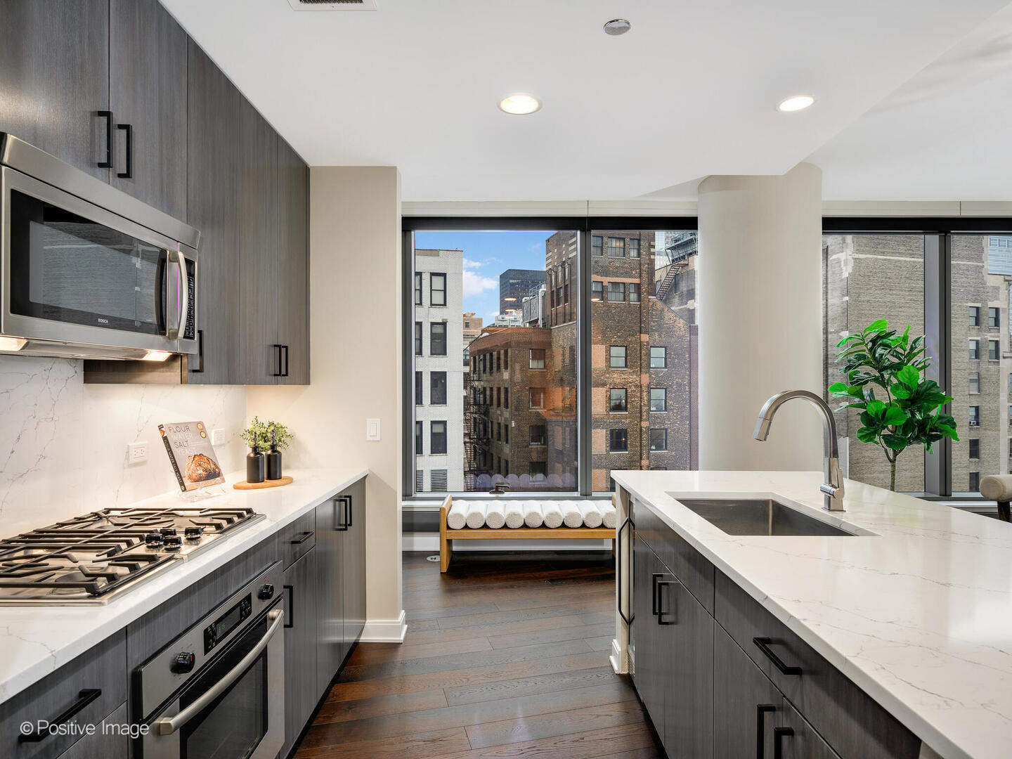60 East Monroe Street, Unit 2001 Chicago, IL 60603 - Photo 12 of 68 a kitchen with a sink and a stove top oven