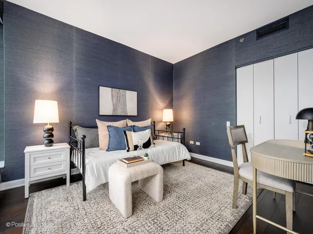 a bed room with a bed and a chair