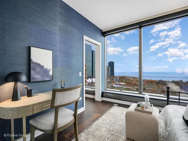 a bedroom with furniture and a large window