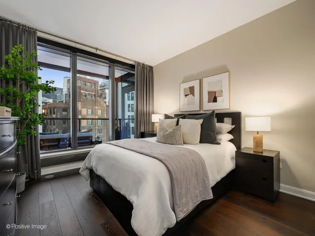 a bedroom with a large bed and a rug