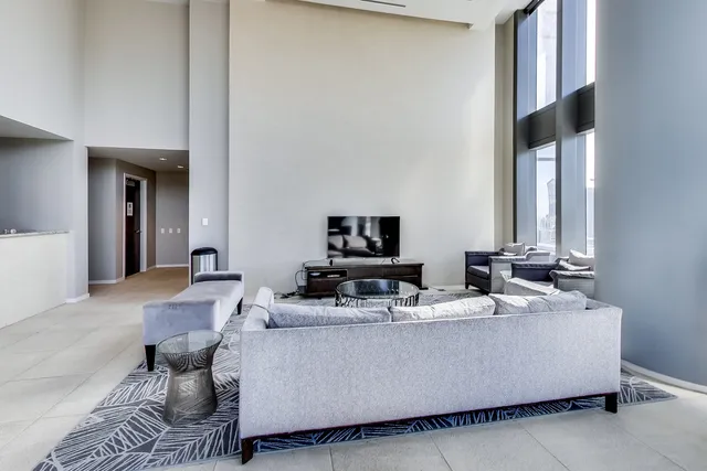 a view of a living room and floor to ceiling window