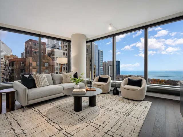 a living room with furniture and floor to ceiling window