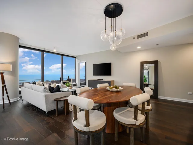 a view of a dining room with furniture wooden floor and chandelier