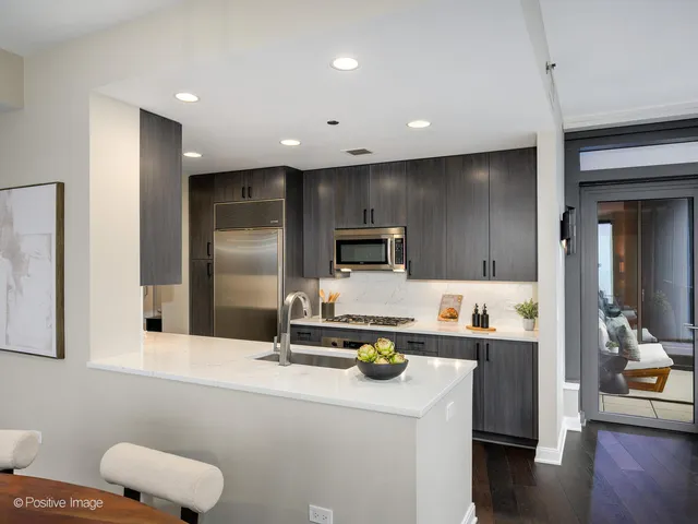 a kitchen with sink refrigerator and microwave