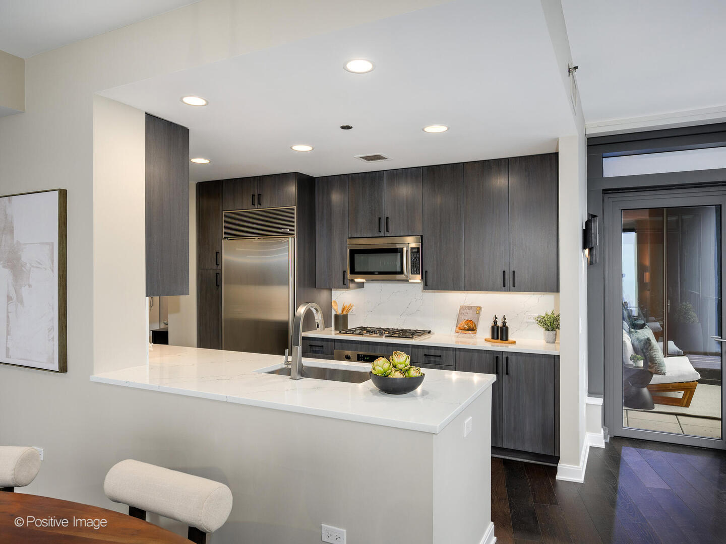60 East Monroe Street, Unit 2001 Chicago, IL 60603 - Photo 10 of 68 a kitchen with sink refrigerator and microwave