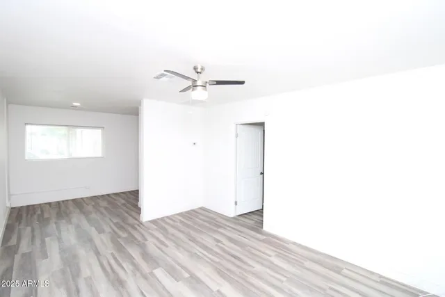 a view of a room with wooden floor