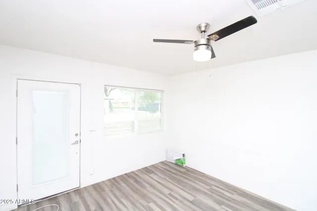 a view of a room with wooden floor and windows