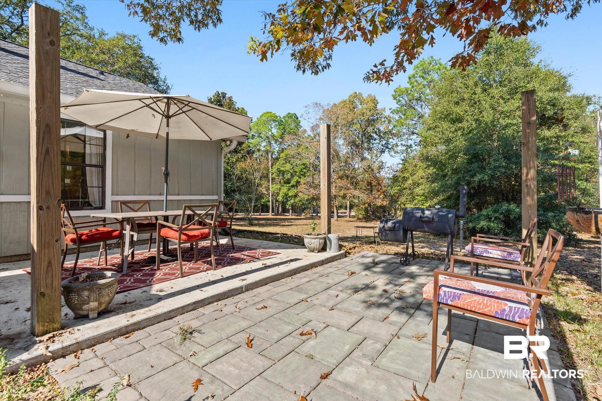 3846 Leslie Road Saraland, AL 36571 - Photo 25 of 40 View of patio / terrace with outdoor dining space and view of wooded area