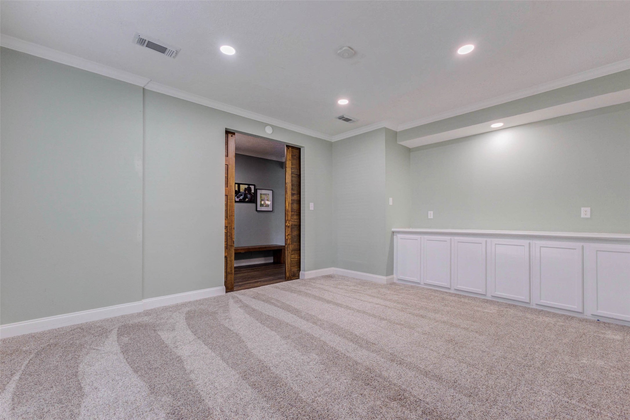 9215 Landry Boulevard Spring, TX 77379 - Photo 7 of 42 Recessed lighting, generous wall space, and custom built ins enhance the functionality of this versatile room, making it ideal for a home office, game room, media space, or additional living area.