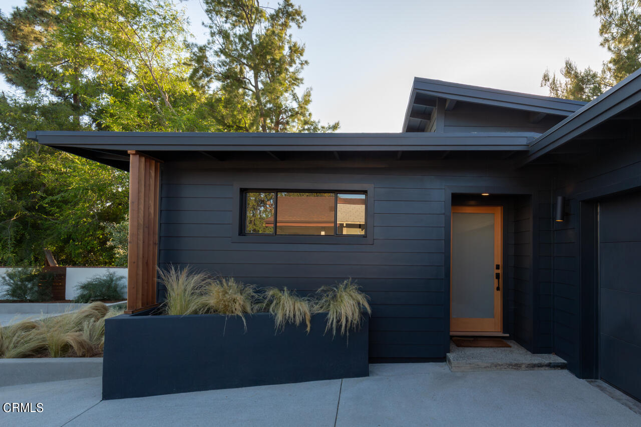 a front view of a house with a garden