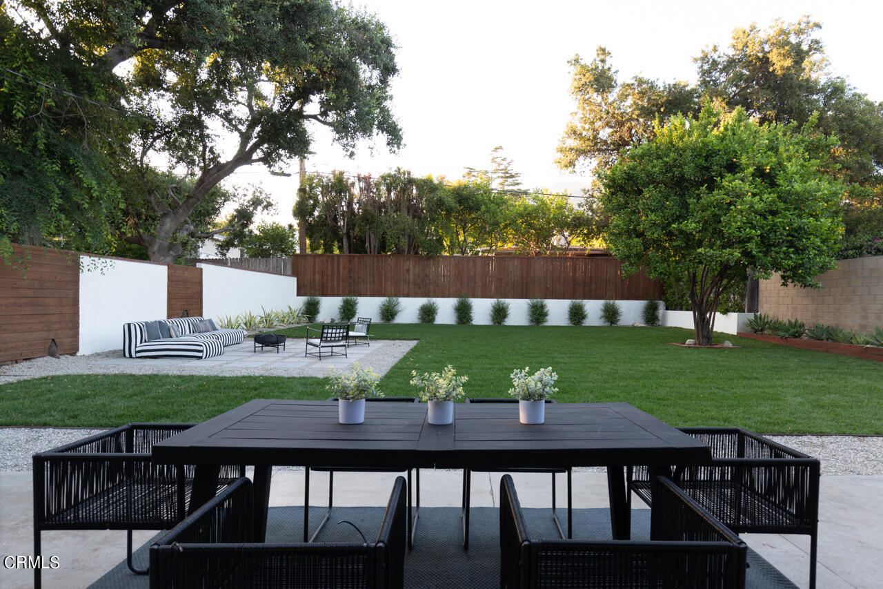 1649 New York Drive Altadena, CA 91001 - Photo 24 of 29 a view of a deck with table and chairs and a large tree