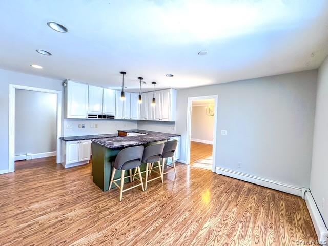 250 Maloney Road Wappingers Falls, NY 12590 - Photo 5 of 24 a living room with stainless steel appliances kitchen island granite countertop furniture and wooden floor
