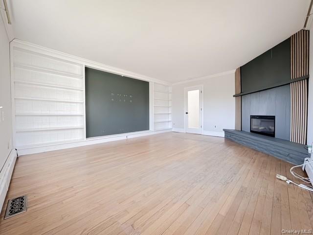 250 Maloney Road Wappingers Falls, NY 12590 - Photo 10 of 24 a view of empty room with wooden floor and fireplace