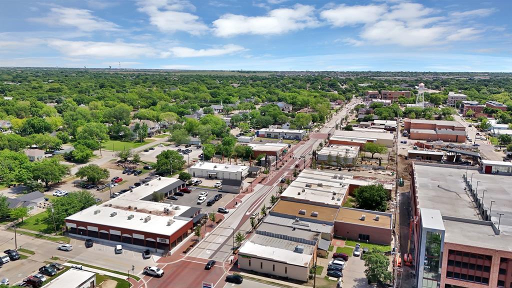 6868 Pecan Street Frisco, TX 75034 - Photo 8 of 8 Aerial perspective showcasing a vibrant urban core with established commercial buildings, ample street parking, and a prominent water tower